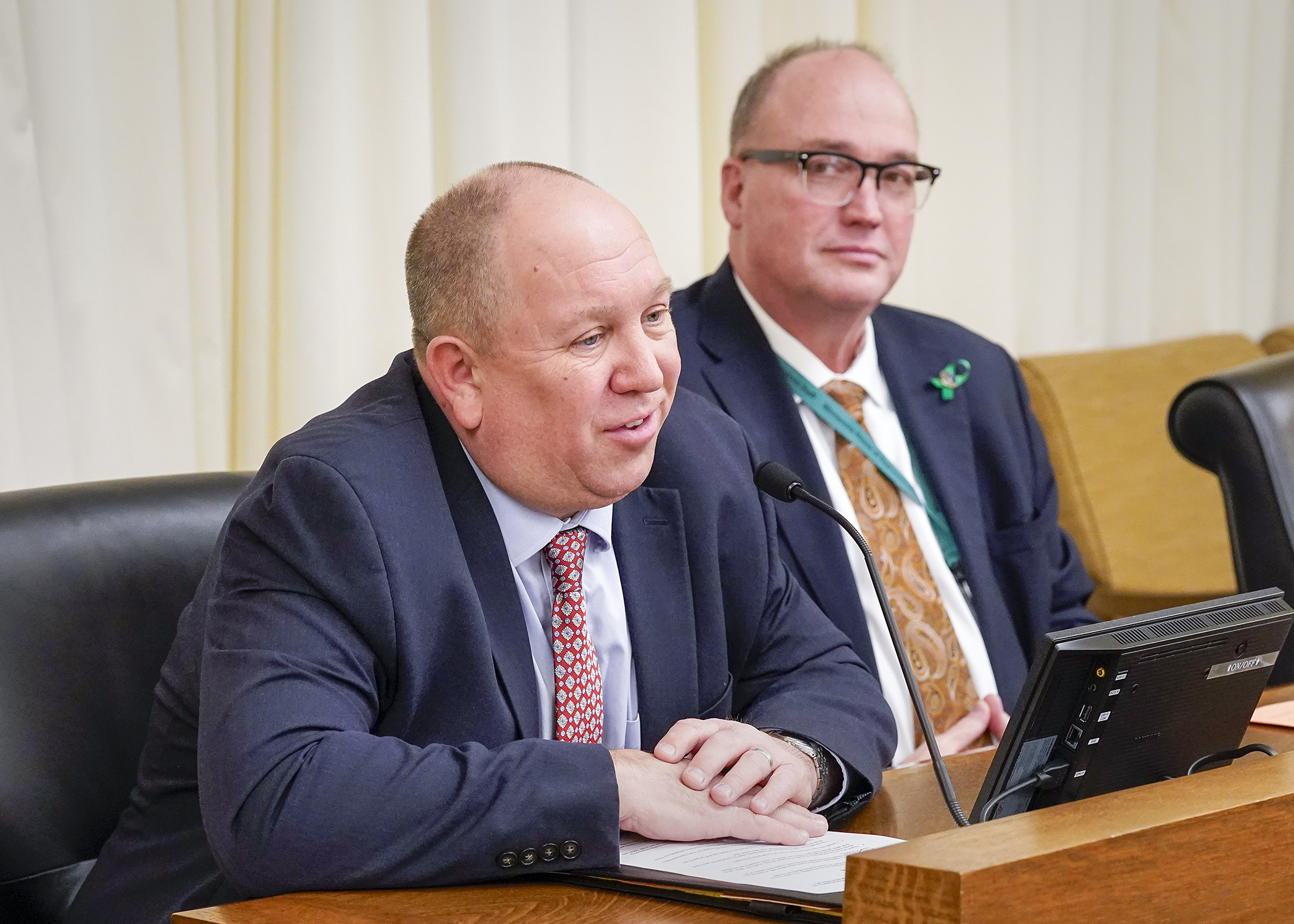 Paul Eger, senior vice president of governmental affairs for the Minnesota Association of Realtors, testifies in support of a bill sponsored by Rep. John Huot, right, that would expand certain targeted property tax refunds. (Photo by Andrew VonBank)